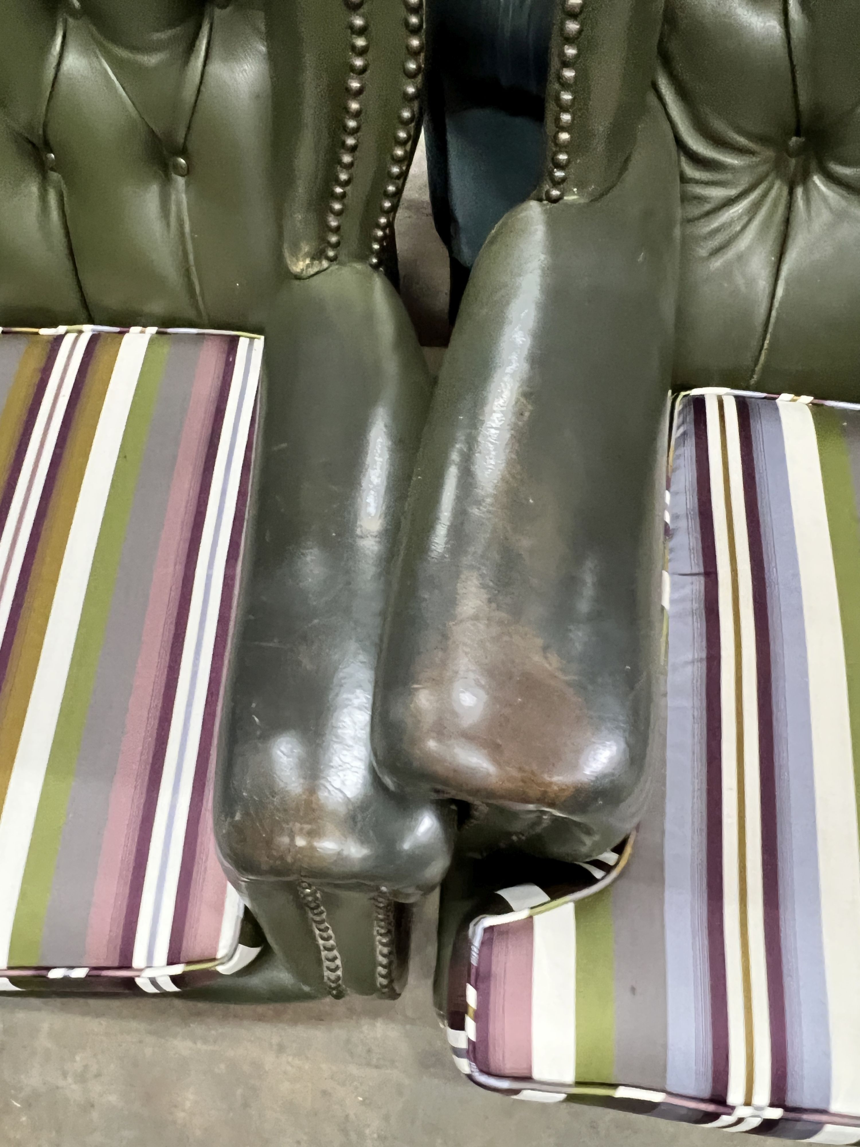 Two Victorian style buttoned green leather wing armchairs